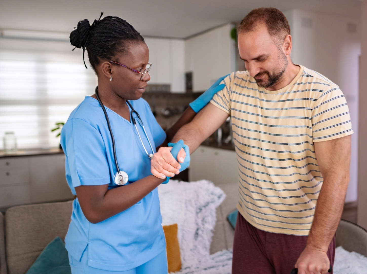 A Caregiver Helps a Patient Regain Mobility in a Home