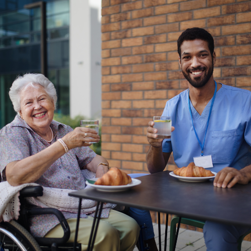 Caregiver having breakfast with his client at cafe _ Personal Care & Companionship