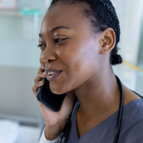 Happy african american female carer talking on smartphone _ Emergency Care